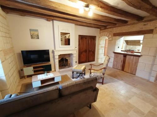 a living room with a couch and a fireplace at Gîte avec vue sur l'Indre in Artannes-sur-Indre