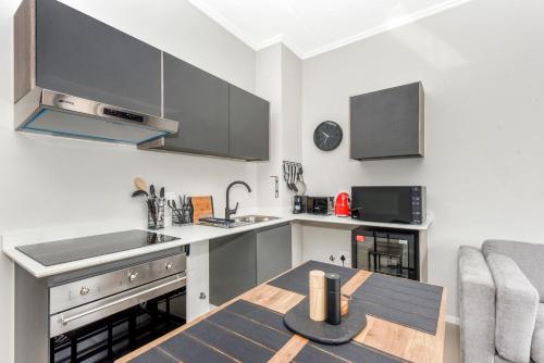 a kitchen with a table and a counter top at The Bailey Apartments in Johannesburg