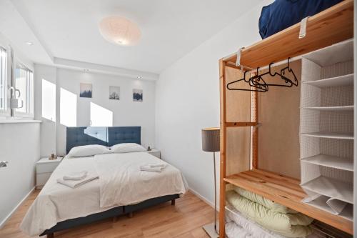 a bedroom with a bed and a book shelf at Prime View Apartments Blanca and Lena in Zagreb