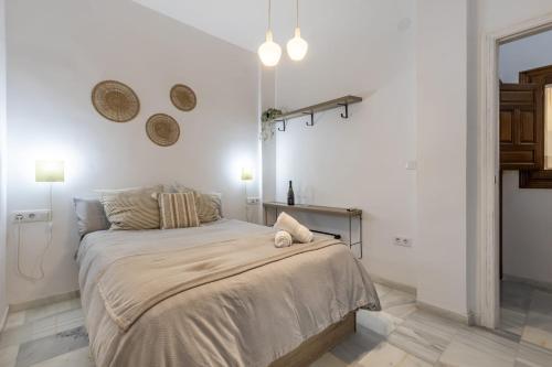 a white bedroom with a large bed in it at Luxury Suite de Trabuco in Granada