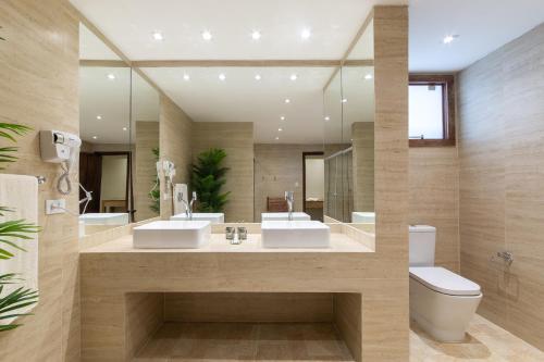 a bathroom with two sinks and a toilet at Pousada La Dolce Vita in Búzios