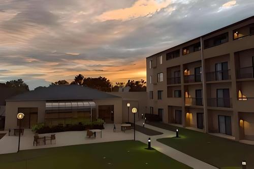 a rendering of a building with a sunset in the background at Comfort Inn & Suites in Arlington Heights