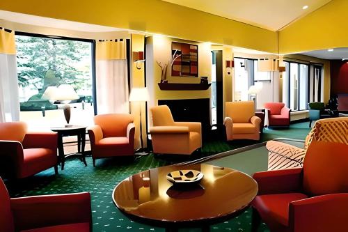 a lobby with couches and chairs and a table at Comfort Inn & Suites in Arlington Heights