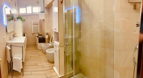 a bathroom with two toilets and a glass shower at Family in Rome in Rome