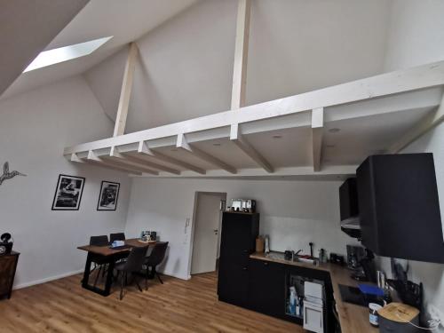 a room with a desk and a table in a loft at Ferienwohnung Seeloft in Emden