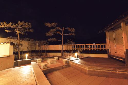 a patio at night with lights on a building at Arimakan in Kaminoyama