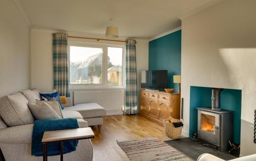 a living room with a couch and a fireplace at The Birdhouse Family Home with Countryside Views in Beal