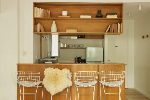 a kitchen with a counter with four chairs and a counter at Hestia At Duhau 2bdr Near Patio Bullrich in Buenos Aires