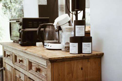 a wooden counter with three products on top of it at Village Del Mar - Corse in Solaro