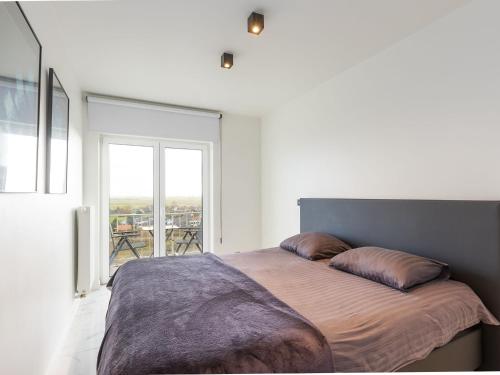 a bedroom with a large bed with two pillows on it at Luxury apartment with stunning sea views in Middelkerke