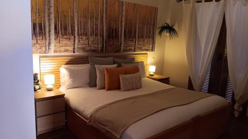 a bedroom with a bed with two lamps on it at Villa Puerto Adriano in El Toro