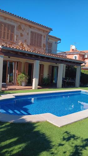 a large swimming pool in front of a house at Villa Puerto Adriano in El Toro