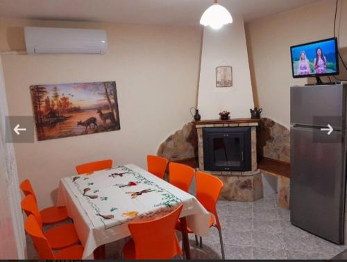 een eetkamer met een tafel en een koelkast bij Къща за гости Еленска свежест in Elena
