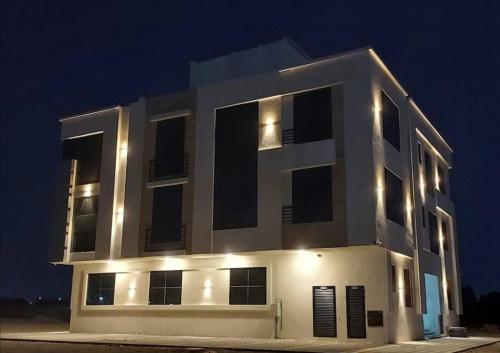 a large white building with lights on it at night at Lovely Studio in Ras al Khaimah