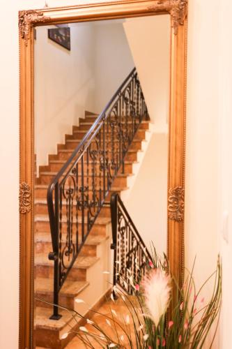 a mirror reflecting a staircase in a house at Apartamenty Przemyśl in Przemyśl