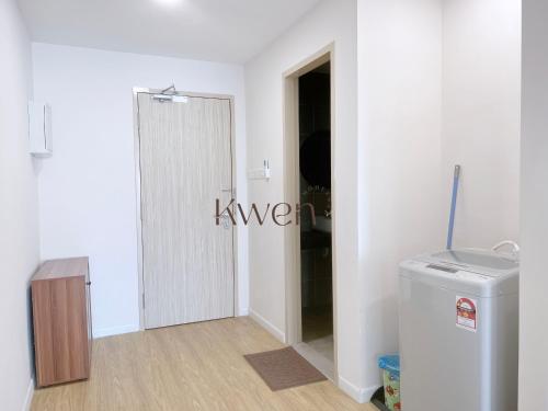 a hallway with a door leading into a room at KWEN Suites-Tanjung Aru InfinityPool Seaview/Airport View in Kota Kinabalu