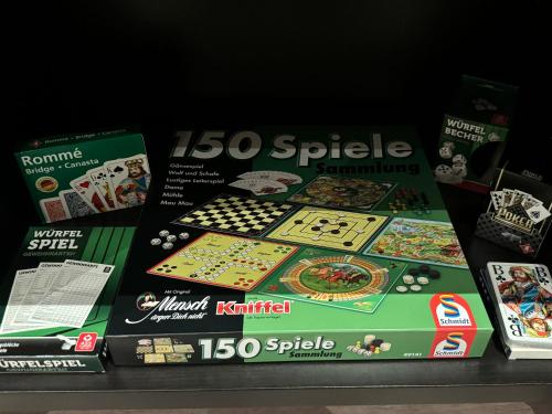 a lego puzzle board game is on a shelf at Belm Ferienwohnung am Bach in Belm