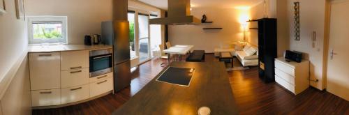 a kitchen with a wooden counter top in a room at 25h GARDEN Apartment PLUS private Beach in Neusiedl am See