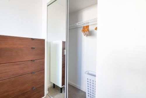 a bedroom with a mirror and a closet at South Beach 2br w heated pool shops dining SFO-1664 in San Francisco