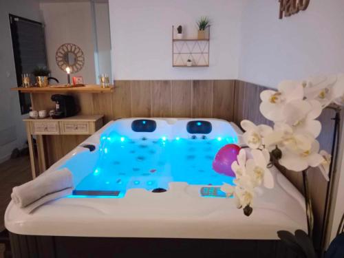 a room with a bed with a blue table and flowers at Ô'BEL AIR in Azur