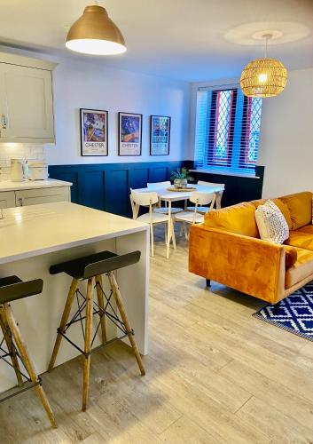 a living room with a couch and a table at Boutique Chapel Apartment within City Walls in Chester