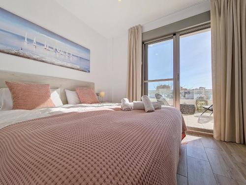 ein Schlafzimmer mit einem großen Bett mit einem großen Fenster in der Unterkunft Los Alcazares Villa - 3010 in Los Alcázares