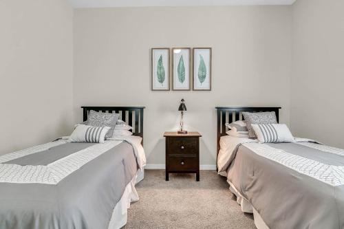 a bedroom with two beds and a table with a lamp at 4 Bedrooms - 3 Bathrooms - Lucaya Village 14-101 in Orlando