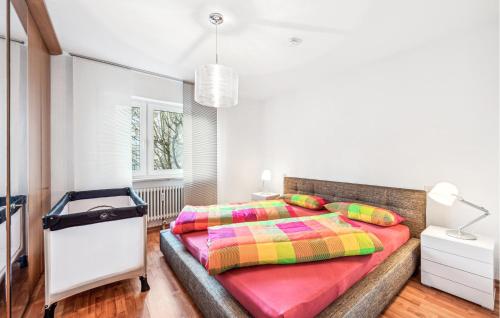 a bedroom with a large bed with colorful pillows at Lovely Apartment In Ulm With House A Panoramic View in Ulm
