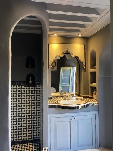 a bathroom with a sink and a mirror at Ryad El Borj in Marrakech