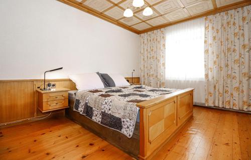 a bedroom with a bed and a large window at Ferienhaus In Klaffer A, H, in Klaffer am Hochficht