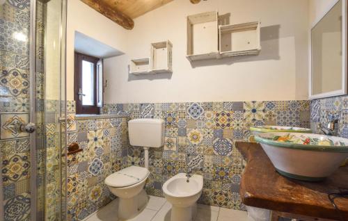 a bathroom with a toilet and a sink at 1 Bedroom Lovely Apartment In San Piero Patti in San Piero Patti