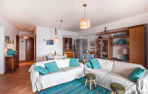 a living room with a white couch and blue pillows at Amazing Apartment In Scilla With Wifi in Scilla