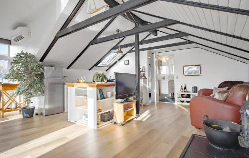 a living room with a couch and a tv at Lovely Home In Hadsund With Wifi in Hadsund