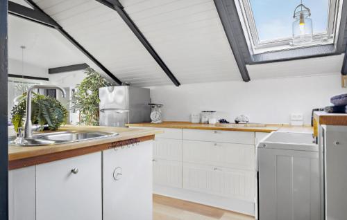a kitchen with white cabinets and a sink at Lovely Home In Hadsund With Wifi in Hadsund