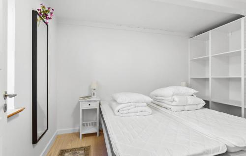 a white bedroom with a bed and a mirror at Awesome Home In Faaborg With Wifi in Fåborg