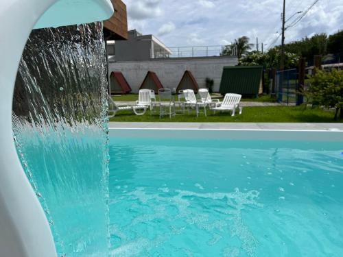a water fountain in front of a swimming pool at Floripa Glamping in Florianópolis