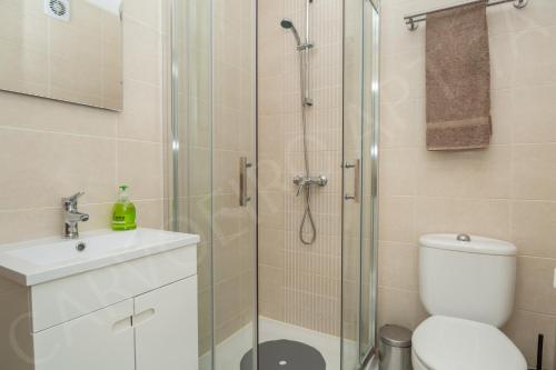 a bathroom with a shower and a toilet and a sink at Carvoeiro Apartment 7A in Carvoeiro