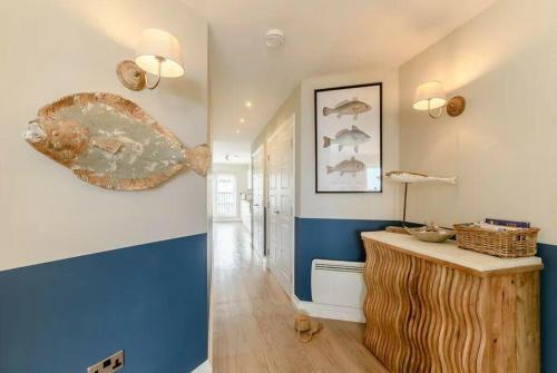 a hallway with blue and white walls and a counter at Northern Hideaways, Seascape in Seahouses