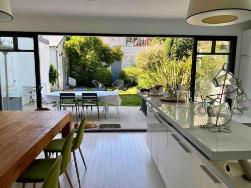 a kitchen and dining room with a view of a patio at Deauville. Grande villa, plage. in Tourgeville