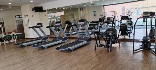 a gym with several treadmills and elliptical machines at KL MARIGOLD APARTMENT At TIMES SQUARE in Kuala Lumpur