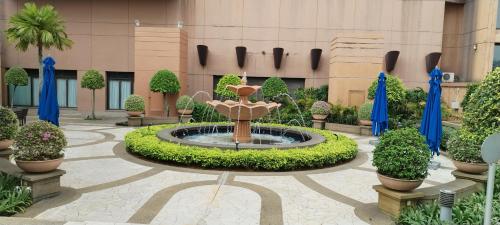 a courtyard with a fountain in front of a building at MARIGOLD APARTMENT At TIMES SQUARE in Kuala Lumpur