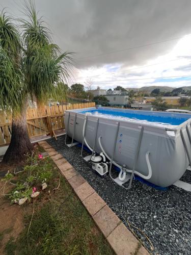 a row of boats sitting next to a swimming pool at Pirata Family House• A 5 min de Poblado Boquerón in Cabo Rojo