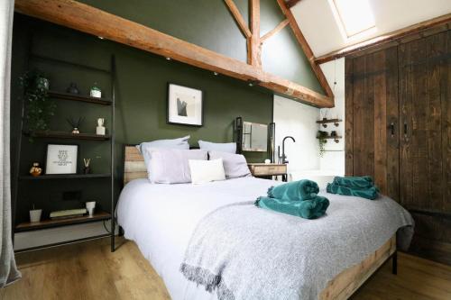 a bedroom with a large bed with a teddy bear on it at A countryside retreat in Chipping Norton