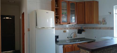 a kitchen with a white refrigerator and a sink at San Luis A 4 del mar Centrica in San Luis