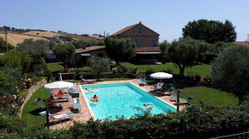uma imagem de uma piscina num quintal em La Villa degli Ulivi em Fermo