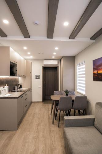 a kitchen and living room with a table and chairs at Senamiesčio apartamentai in Anykščiai