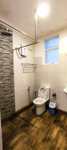 a bathroom with a toilet and a sink at Moon Plains Luxury Apartments in Nuwara Eliya
