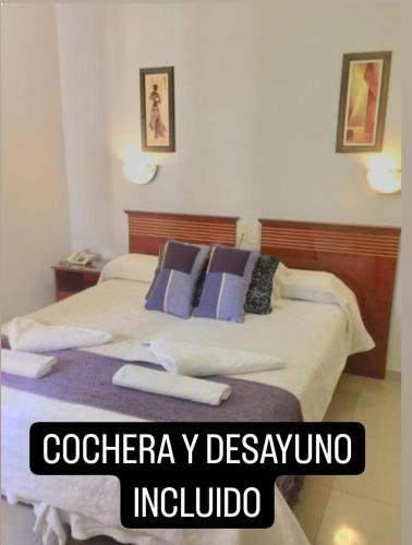 a bedroom with a bed with two towels on it at Hotel Plaza San Juan in San Juan