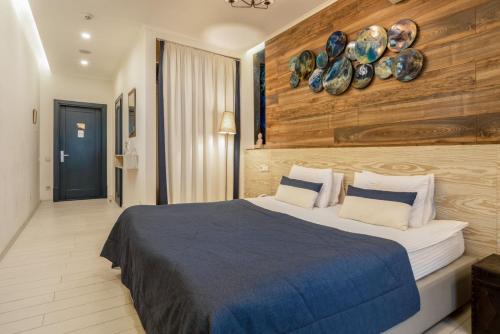 a bedroom with a bed with plates on the wall at Design Hotel Skopeli in Odesa