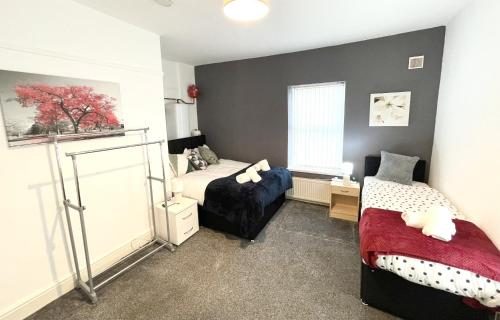 a bedroom with two beds and a window at Beautiful Mordern Apartment with Bathroom in Seacombe